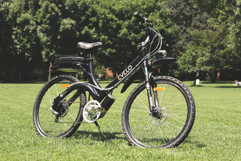 a bicycle parked in the grass in a park